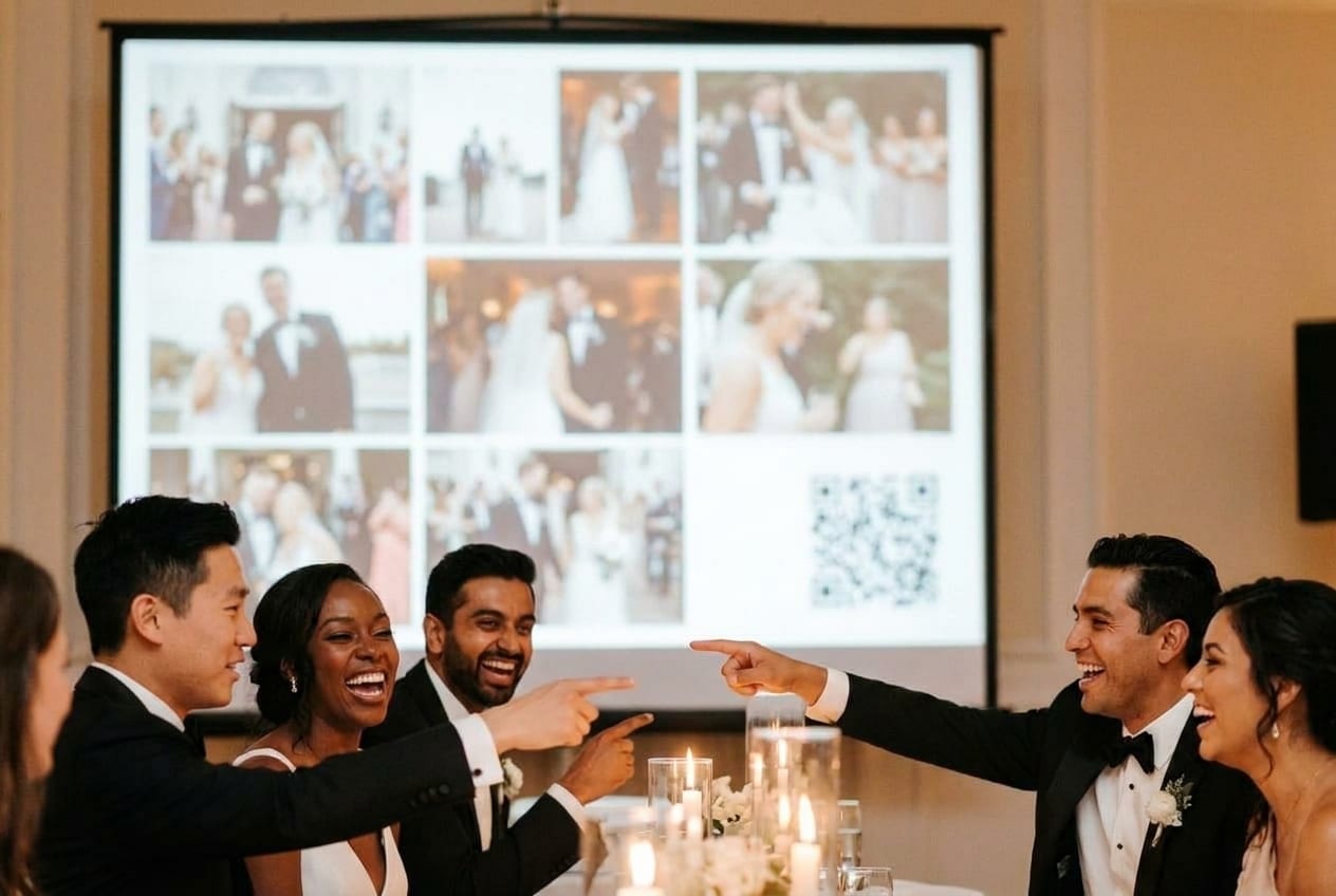 Guests watching a live photo wall projected on the screen at an evening reception